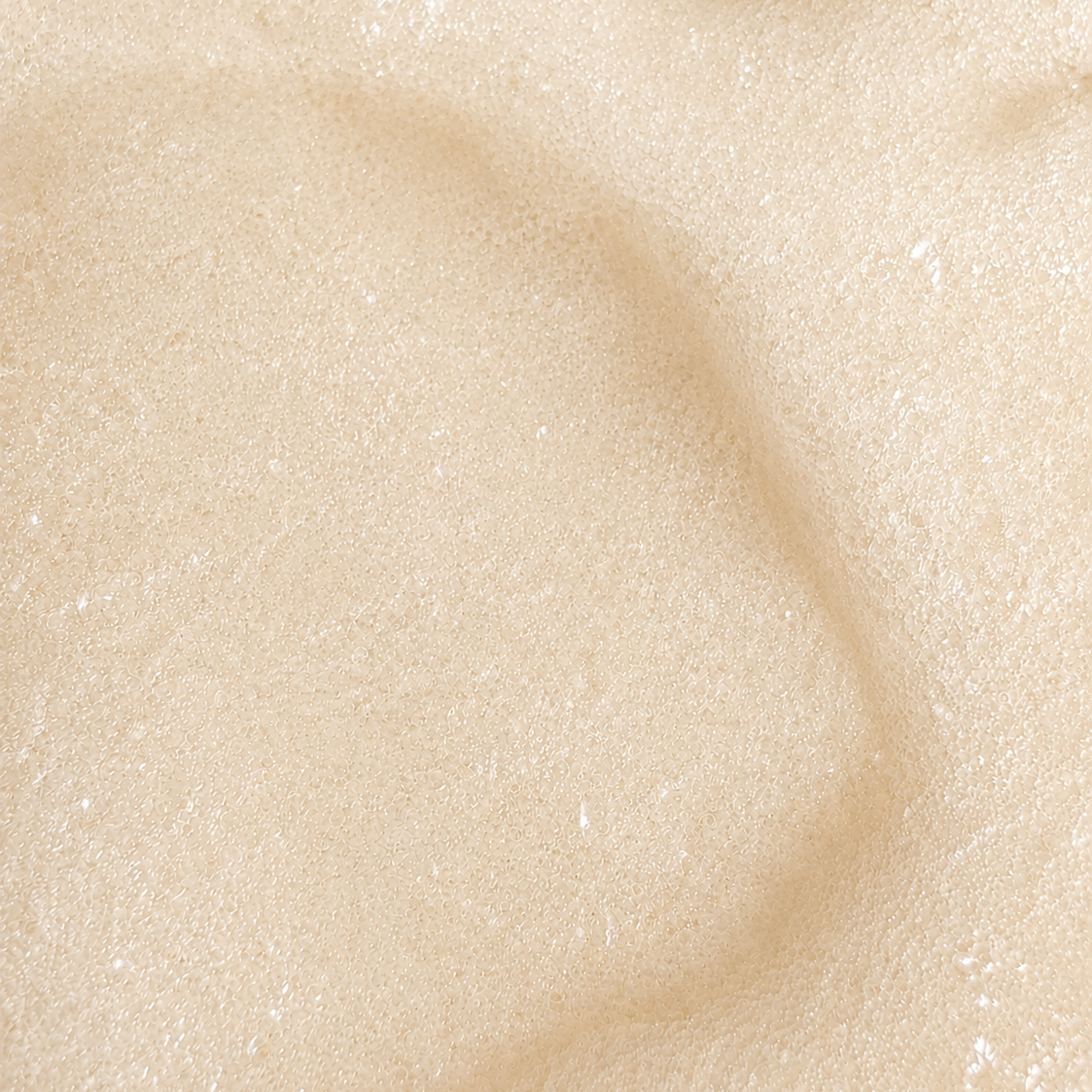 Macro view of Rivahna Vanilla Cream Slime Sugar Scrub texture featuring a soft creamy exfoliating formula with fine sugar granules for gentle body exfoliation and radiant skin.